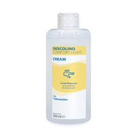 A 500 ml tube of Dr. Schumacher GmbH DESCOLIND COMFORT LIGHT CREAM for sensitive skin, with a yellow-and-white label and a blue hand cream symbol.