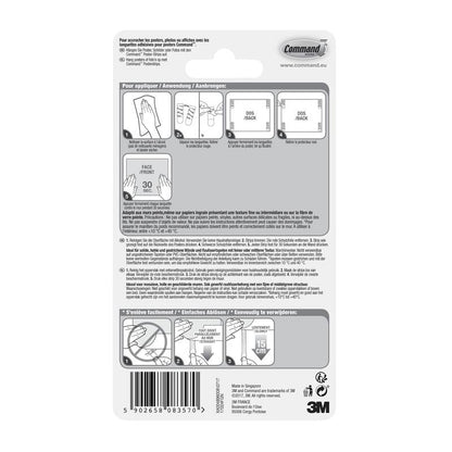 Rückseite einer Packung Command™ Poster-Strips 17024 von 3M Deutschland GmbH mit bebilderter Schritt-für-Schritt-Anleitung für rückstandsfreies Befestigen und Poster befestigen in mehreren Sprachen, mit Diagrammen, Barcode und 3M Branding unten rechts.