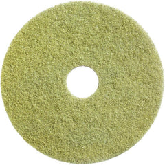The Diversey Twister Pad (yellow) from Diversey Deutschland GmbH & Co. OHG is a round restoration pad with a hole for cleaning and restoring stone floors; it is shown from above against a white background.
