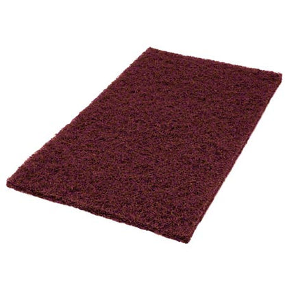 The Twister Pad purple, square from Diversey Deutschland GmbH & Co. OHG is ideal for the maintenance cleaning of coated hard floors and has a chestnut brown, textured surface. Here depicted on a white background.
