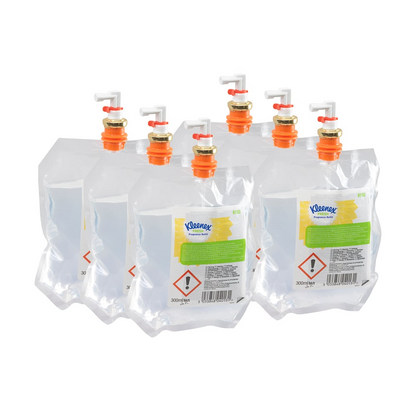 Six transparent Kleenex® Scented Air Freshener Fresh Refill Pack 6190 by Kimberly-Clark GmbH, each equipped with an orange-white dispensing valve and warning notices, are packed in a 6-pack carton - ideal for scent air freshener systems.
