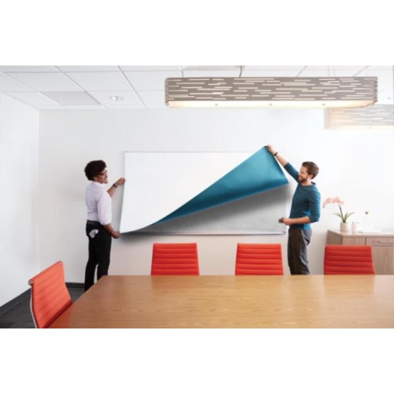 Two people are applying a large Post-it® Easy Erase Whiteboard Surface (white) from 3M Deutschland GmbH over a whiteboard in a conference room. The room is equipped with red chairs, a wooden table, and a modern ceiling light.