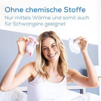 A smiling woman holds pink and blue baby socks on a bed. German text above: "No chemicals. Only with heat and therefore also suitable for pregnant women." Ideal with discontinued item: Beurer insect bite healer BR 60 from Beurer GmbH.