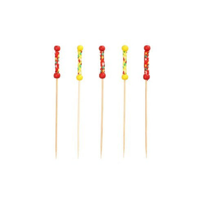 Five PAPSTAR 250 finger food picks from PAPSTAR A wooden GmbH sign, biodegradable, with colorful beads and decorations in red, yellow, and multicolored accents, arranged vertically against a white background.