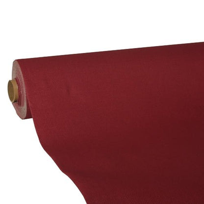 A roll of deep red "ROYAL Collection" tissue tablecloth from the PAPSTAR The GmbH is partially unrolled from a cardboard roll. The high-quality tissue ensures a smooth, opaque appearance.