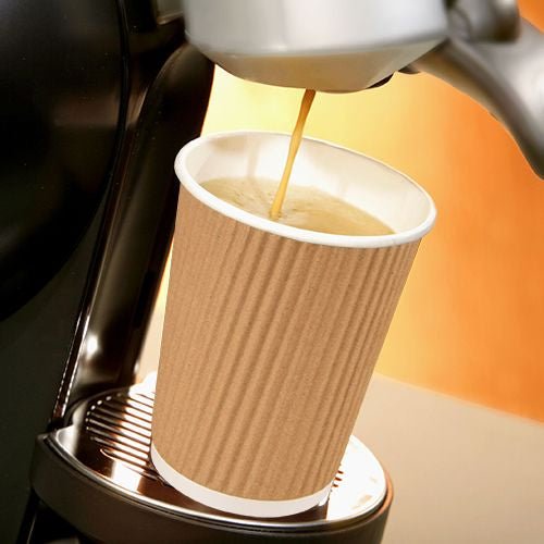A PAPSTAR A Ripple Wall cardboard cup (Ø 9 cm, 13.7 cm tall) is placed on a coffee maker and filled with coffee.
