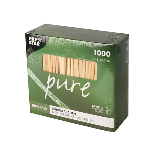 A green box with the inscription "pure" contains 1000 PAPSTAR bamboo stir sticks (13.5 cm, biodegradable). The logo of PAPSTAR GmbH is located at the top left; icons indicate the eco-friendly bamboo material of the packaging.