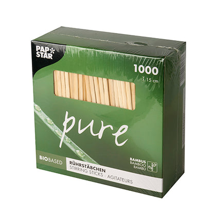 A green box with the inscription "PAPSTAR 1000 stir sticks, bamboo 'pure'" from PAPSTAR GmbH contains 1000 eco-friendly, biodegradable 15 cm long bamboo stir sticks and features a transparent window.