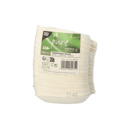 A stack of 50 small, white PAPSTAR finger food plates made of sugarcane "pure", biodegradable, packaged in plastic and with recycling info as well as the labels "Bio-based" and eco-friendly by PAPSTAR GmbH.