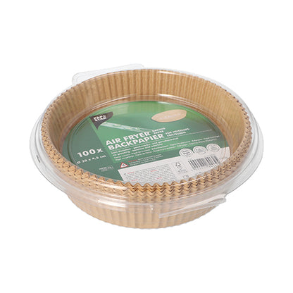 A transparent plastic container from PAPSTAR GmbH holds 100 round, brown "PAPSTAR 100 baking papers for air fryers height 4.5 cm" with a green-white label with product information and instructions for even browning.