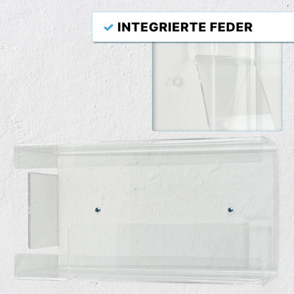 Der ARNOMED Handschuhspender zur 3-fach Befüllung von ARNOWA GmbH aus transparentem Acryl ist mit zwei Schrauben an einer weißen Wand montiert. Ein Detailbild zeigt die integrierte Feder. Text: "Integrierte Feder".