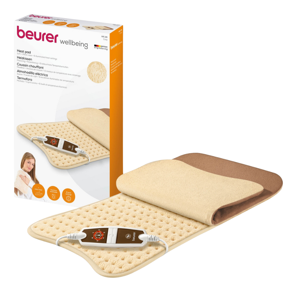 Image of a Beurer HK 115 Comfort Heating Pad by Beurer GmbH. The beige fluffy XXL heating pad comes with an integrated control unit with 6 heat settings. The packaging box behind it shows the heating pad in folded and flat positions, highlighting its OEKO-TEX® STANDARD 100 certification, product details, and brand graphics.