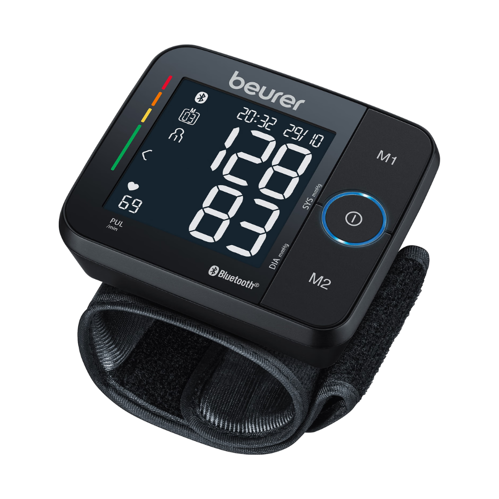 The Beurer wrist blood pressure monitor BC 54 with Bluetooth from Beurer GmbH shows a reading of 120 over 83. The device with its elegant black casing also displays additional indicators for pulse (69 beats/min), time (20:32), and date (29/10). It features Bluetooth connectivity, arrhythmia detection, and buttons labeled M1 and M2.