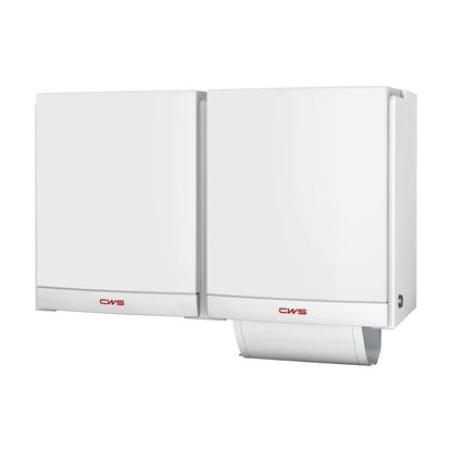 Two white CWS front panels for the DUO cloth towel dispenser from CWS are mounted side by side. The dispenser on the right has a partially pulled-out paper towel; both feature the red CWS logo, highlighting their hygienic design.