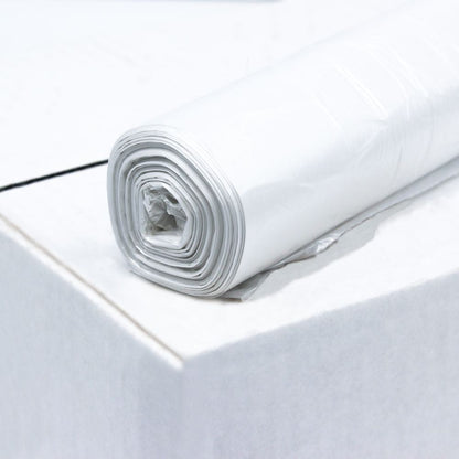 A roll of DEISS HDPE garbage bags 80 liters, 56095, white from EMIL DEISS KG (GmbH + Co.) is placed on a box. The roll is neatly rolled up, while the surface of the box looks smooth and clean.