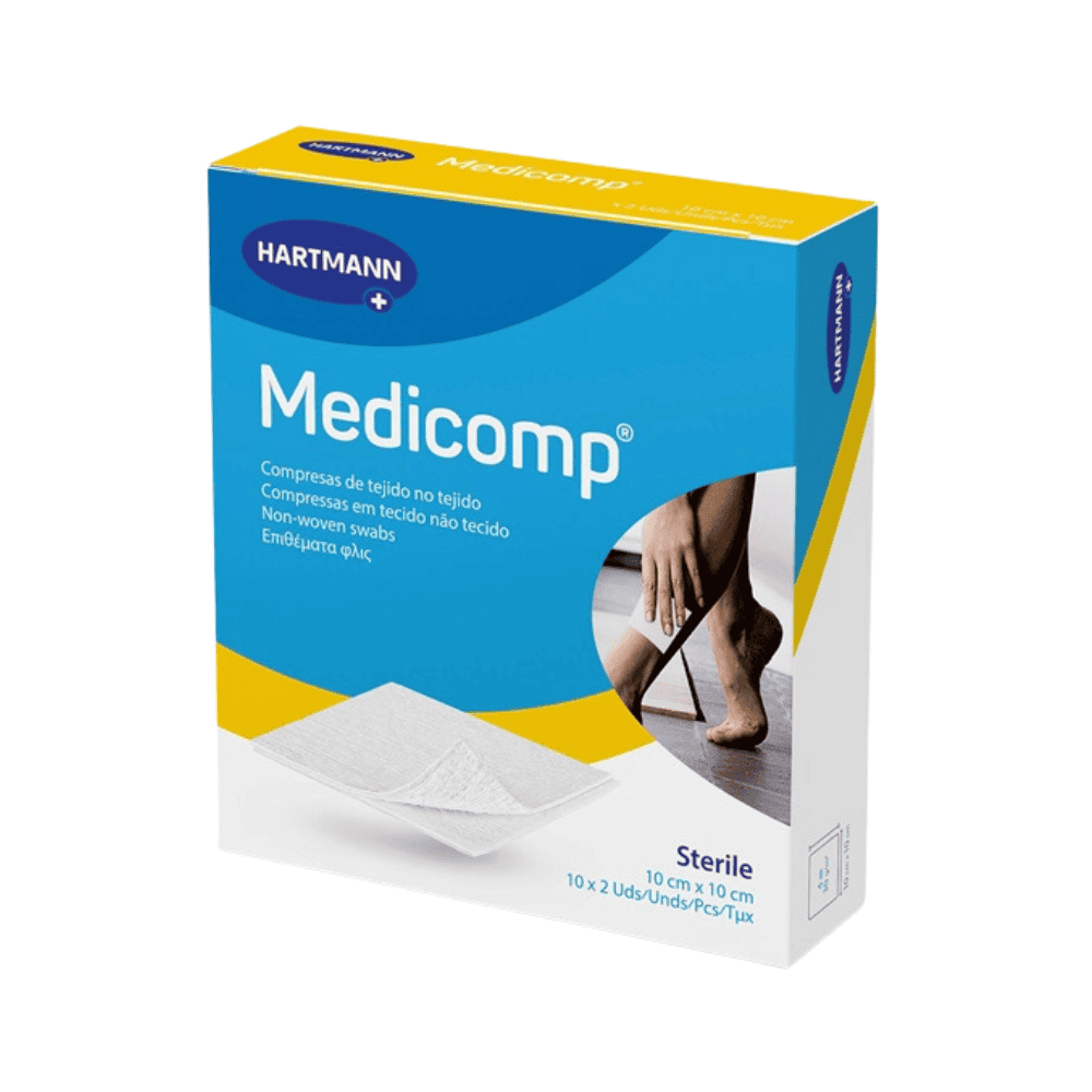 A box of sterile Hartmann Medicomp® non-woven compresses in various sizes – 25 x 2 pieces from Paul Hartmann AG. On the front, a person is depicted applying a swab to their leg, with additional loose sterile non-woven compresses shown in front.