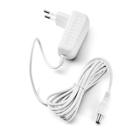 The Paul Hartmann AG Veroval AC/DC Adapter P1 features a white, two-pin plug on the left and a long, coiled cable with a cylindrical connector on the right. Its ribbed sides provide a secure grip, making it ideal for powering devices such as the Veroval upper-arm blood pressure monitor.