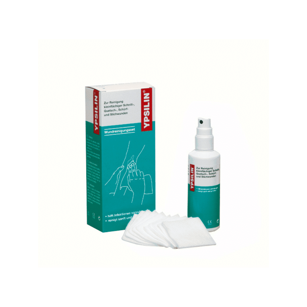 The Holthaus Medical YPSILIN® wound cleaning set from Holthaus Medical GmbH & Co. KG contains a box, a bottle, and several gauze compresses. Both the box and the bottle have a white background with blue-green and red accents and bear the German inscription "YPSILIN". The Holthaus Medical bottle is equipped with a spray nozzle, while the gauze compresses are white squares intended for wound cleaning.