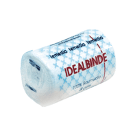 A rolled white gauze bandage labeled “Holthaus Temedia® Ideal Bandage, with bandage clip—1 bandage” in red text. The packaging features a blue cross pattern and displays “100% cotton” and “8 cm.” The brand name “Holthaus Medical GmbH & Co. KG” is repeated at the top in blue.