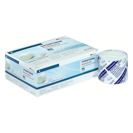 Eine Holthaus Medical Ypsiform Polsterbinde Polyurethan-Filmpflasterrolle neben ihrer Verpackungsschachtel. Die Schachtel ist blau und weiß mit Text und Produktbildern, und die Rolle ist teilweise