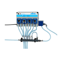 The ARENAS-P4 wall-mounted dosing system from Johannes Kiehl KG features four individually controlled, blue-marked 18-L/h pumps connected by transparent hoses for precise liquid dispensing.