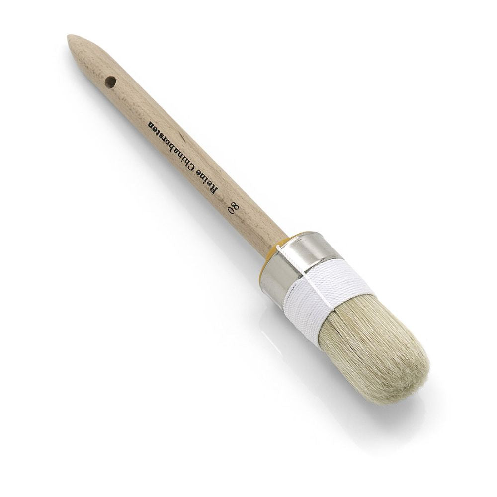 The Nölle Profi Brush painter's round brush features a round wooden handle with a metal ferrule, light bristles made of pure light Chinese bristle for excellent quality, and a white fabric trimming on the ferrule. The handle is elegantly labeled with text. Perfect for painting projects.