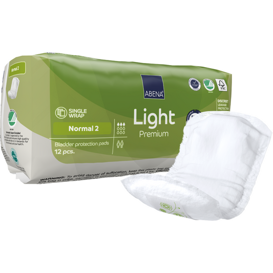 Abgebildet ist eine Packung ABENA Light Normal 2, Premium (12 Paare) von Abena Re-Seller GmbH, mit einem Pad außen. Die grün/weiße Verpackung unterstreicht den diskreten Schutz und zeigt klare Produktinfos und Logos.