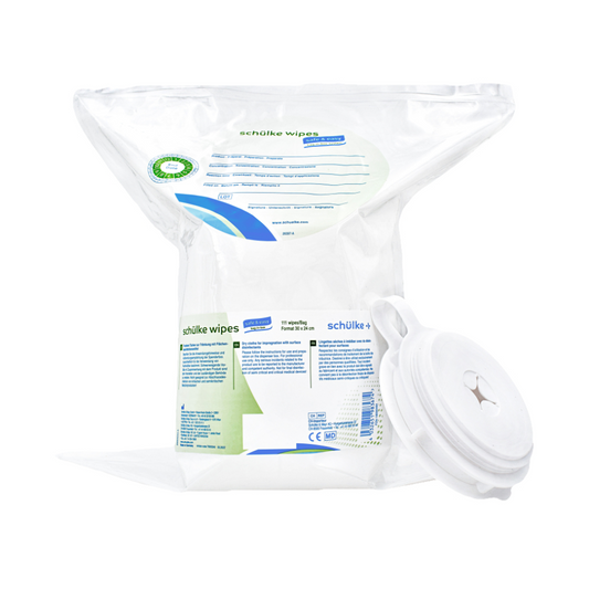 Eine Packung Schülke & Mayr GmbH Schülke wipes safe&easy Tücher zur Tränkung mit Flächendesinfektionsmittel im transparenten Kunststoffspender mit Schnappdeckel. Das Etikett enthält Text und ein grünes Kreuzsymbol, das auf die Verwendung als Medizinprodukt hinweist.