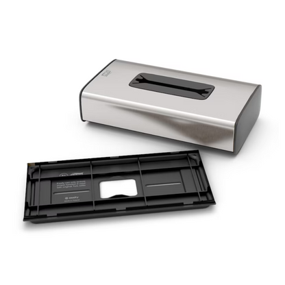 Der Tork 460013 Spender für Kosmetiktücher Image Line F1, ein wandmontierter Tissuespender aus Edelstahl von TORK – Essity Professional Hygiene Germany GmbH, wird mit abgenommener und vorgesetzter abnehmbarer Rückwand gezeigt. Dieser Spender mit elegantem Edelstahl-Design und einem Sichtfenster an der Oberseite ermöglicht einfaches Nachfüllen und Einzelblattentnahme in öffentlichen Toiletten.