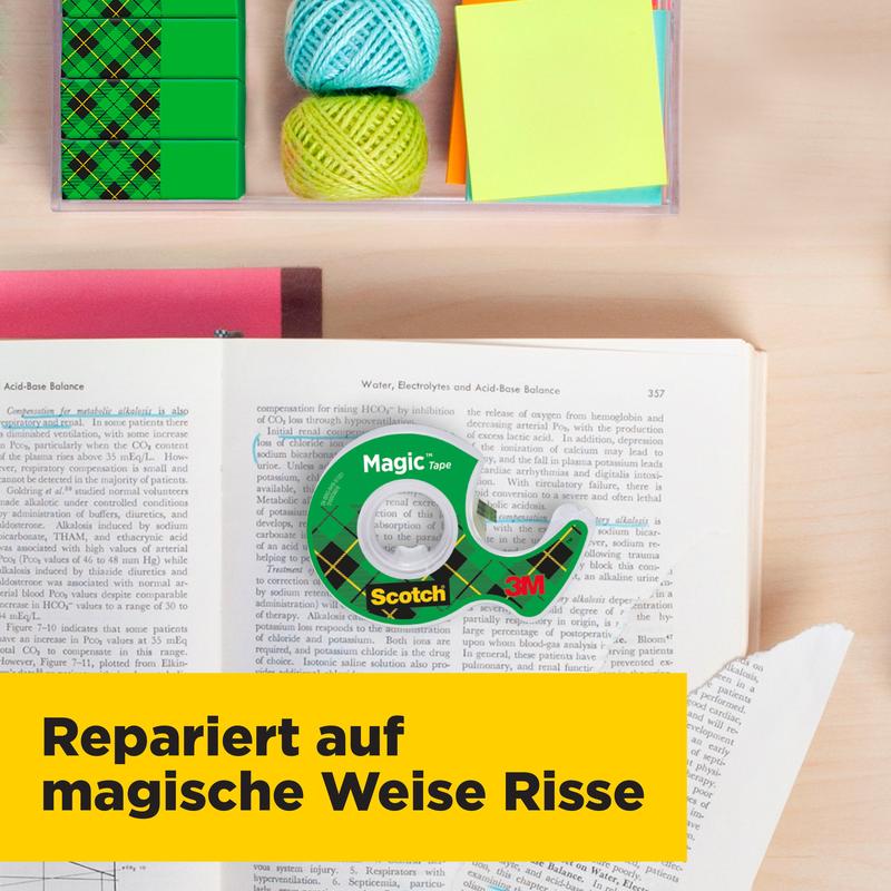 A roll of Scotch® Magic™ Invisible Tape refill pack (19 mm x 25 m) from 3M Deutschland GmbH sits with its dispenser on an open book, surrounded by colorful sticky notes, yarn balls, and a box of paper clips. A yellow banner reads: "Magically Repairs Tears."