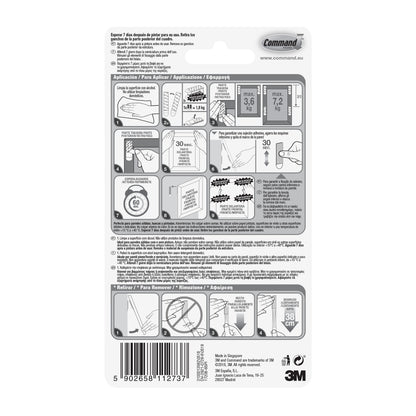 Rückseite der 3M Deutschland GmbH Große Command™ Bilder-Montage Strips L, 6 Sets, zeigt Anbringungs-/Entfernungsschritte in Englisch, Spanisch und Französisch mit Diagrammen, Gewichtsgrenzen, Herstellerinformationen und Barcode am unteren Rand.